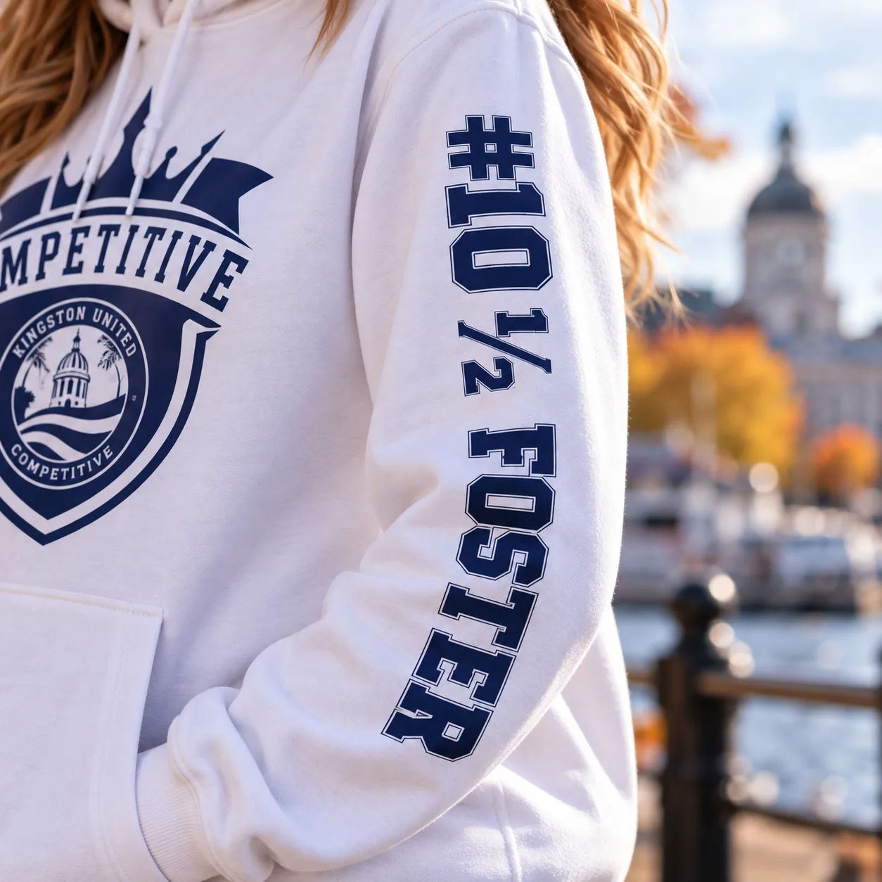 Close-up of the #10½ FOSTER print running down the sleeve of a white Kingston United hoodie