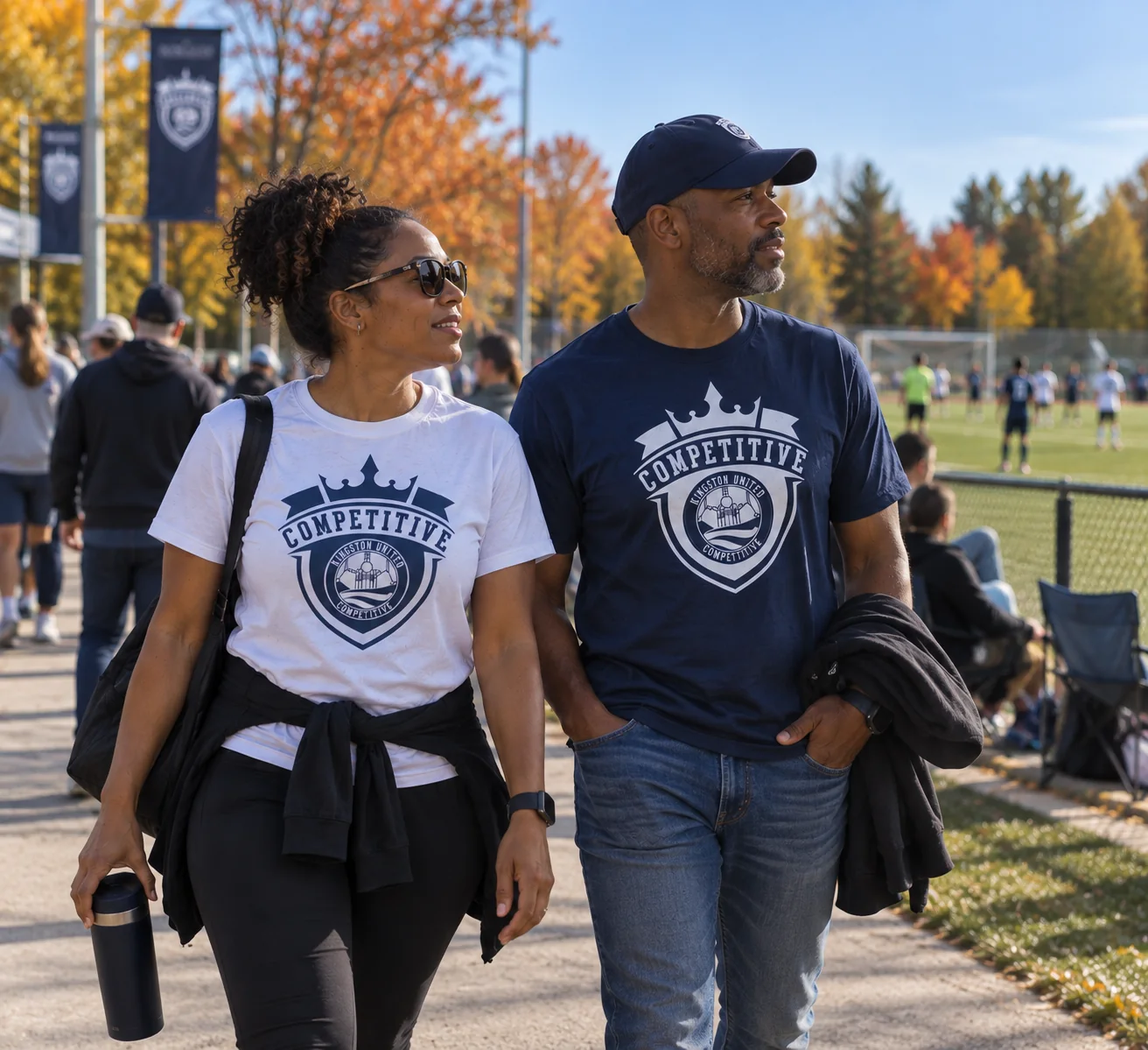 Parents wearing navy and white Kingston United Competitive Heavyweight Tees at the field