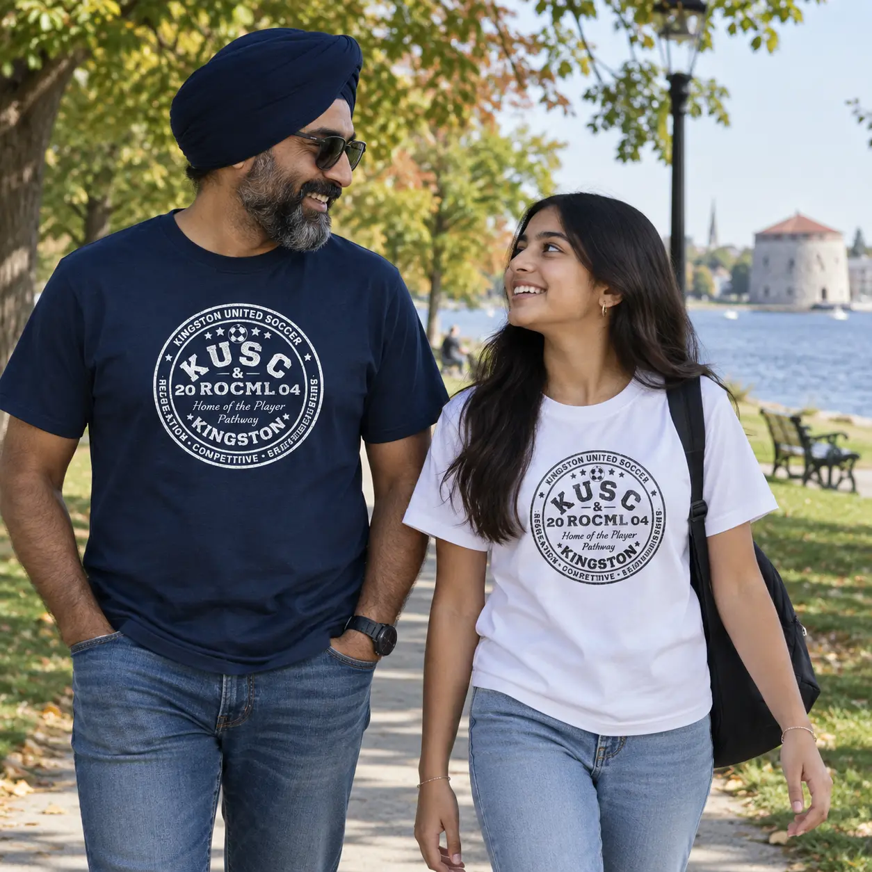 Family wearing navy and white Kingston United Heavyweight Tees by the Kingston waterfront