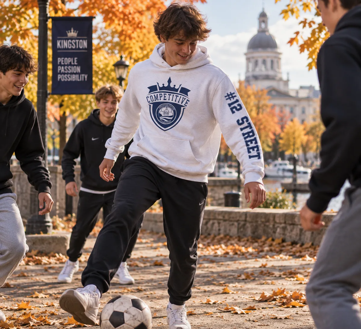 Player wearing the white Kingston United Competitive Hoodie outdoors in Kingston