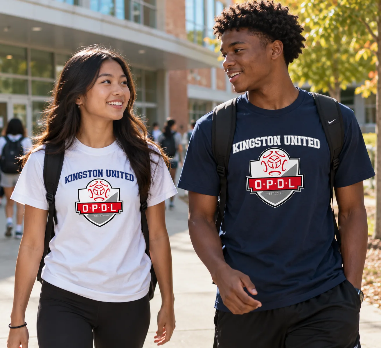 Two players wearing white and navy Kingston United OPDL Heavyweight Tees